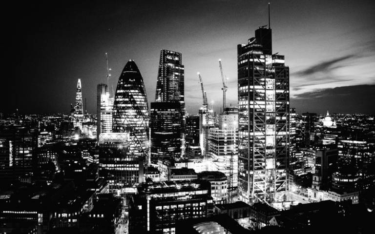 Black and white image of City of London skyline at night - Photo by Dil on Unsplash