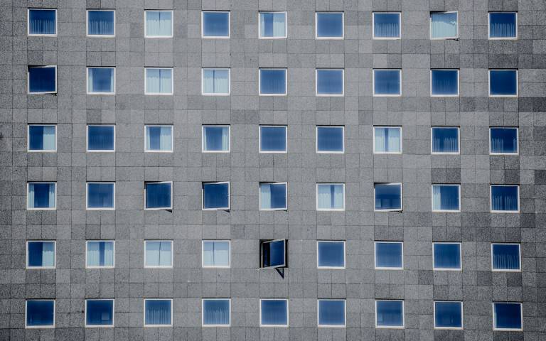 Grey building exterior with multiple windows