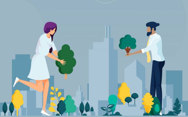 A man and a woman in suits planting trees, or 'greening' a city scape