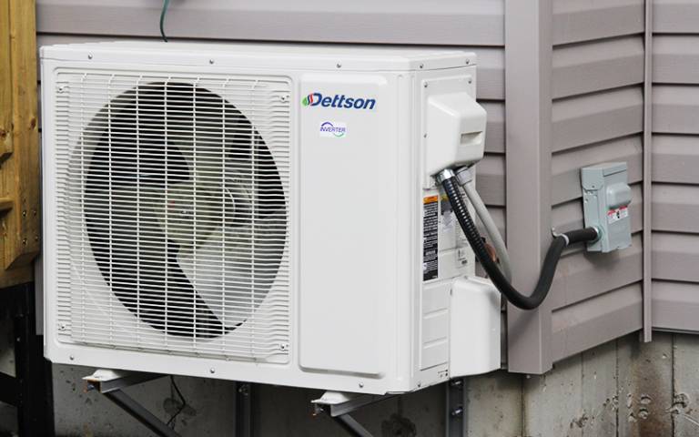 Photo of a heat pump outside a house 