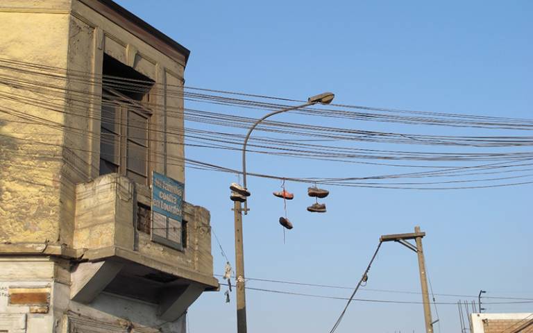 Photo shows power cables and a building in Lima, Peru