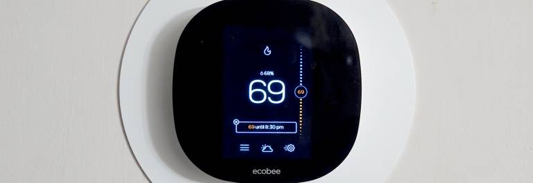 Photo of a digital thermostat on a wall