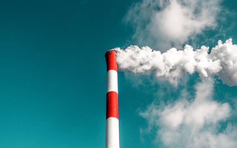 Smoke coming out of chimney against blue sky - Photo by veeterzy on Unsplash