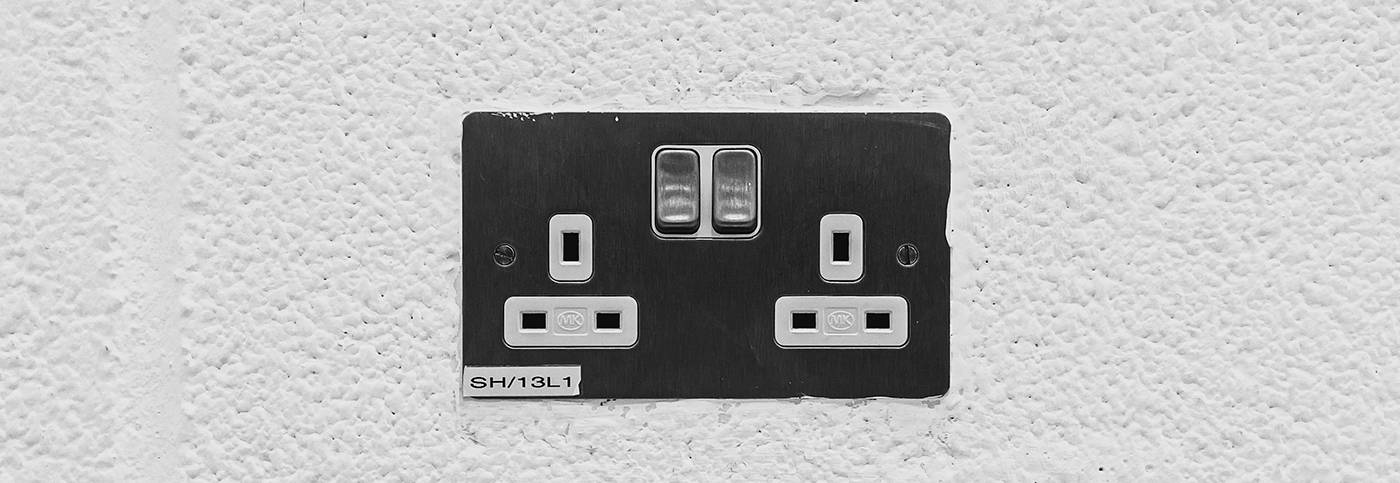 Electrical plug point on white wall