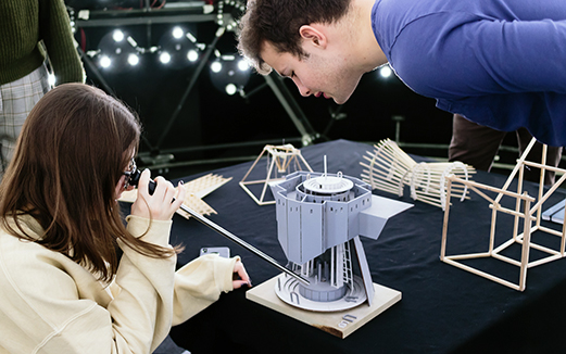 Student testing light levels on an architectural model in The Bartlett's artificial sky