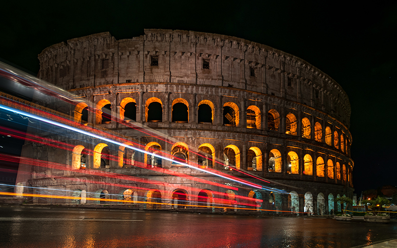 Photograph capturing lights around the coliseum in Rome