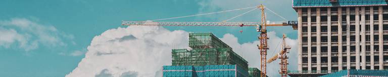 Images of cranes being used to construct a building