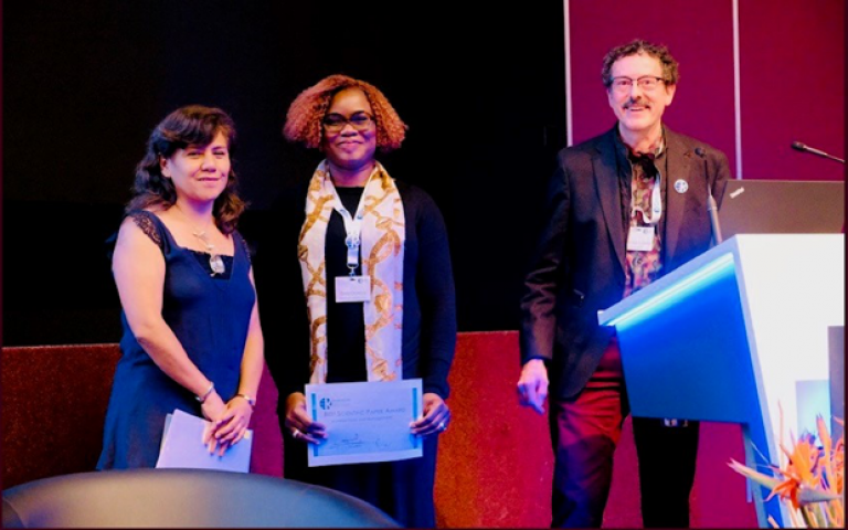 Dola Oluteye receding her award at the World Economic Forum Conference
