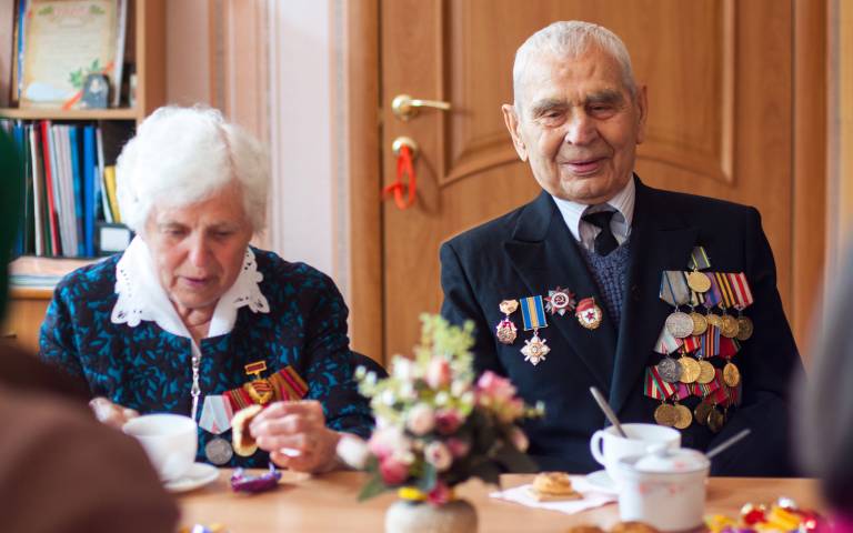 Elderly man and woman having tea