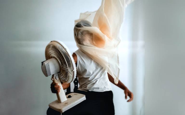 Photo Of person holding an electric fan
