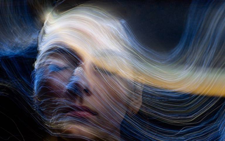 Picture of a woman with a digital representation of waves moving around her head