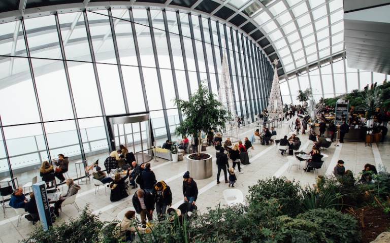 Photo of a large atrium with plants and people