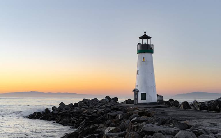 Photo shows Walton Lighthouse in Santa Cruz, California, during sunrise.