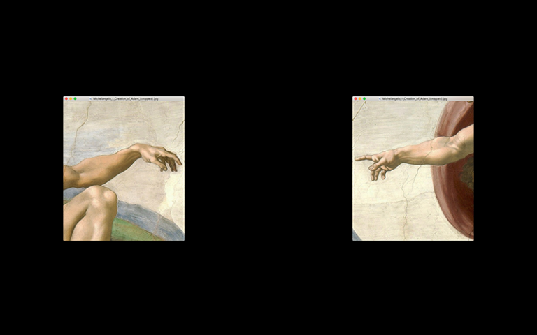 Photo shows the hands of God & Adam from Michelangelo's Creation of Adam separated on a computer screen.