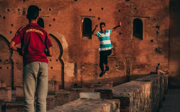 Photo shows teens playing around the walls of the Koutoubia Mosque in Marrakech.