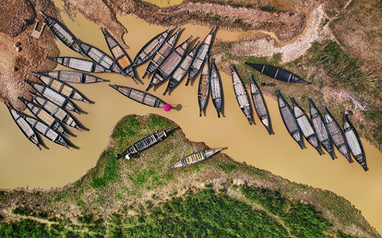 Aerial view of wooden boats along the shores of the freshwater waterways in Ratargul Swamp Forest