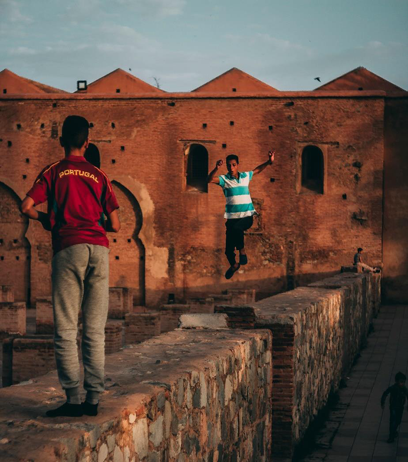Photo shows teens playing around the walls of the Koutoubia Mosque in Marrakech.