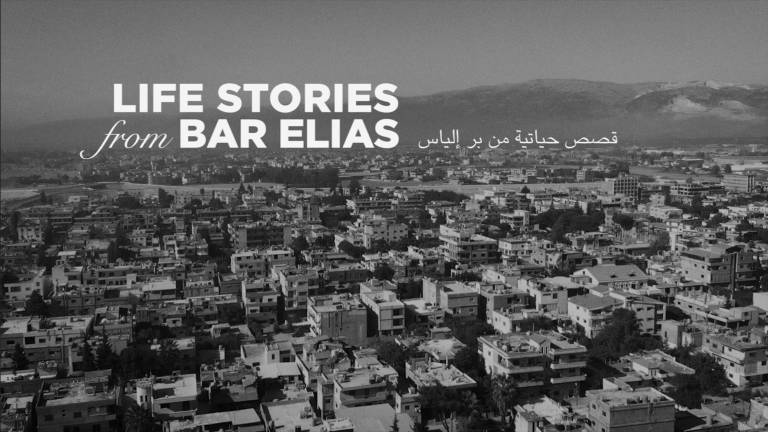 Black and white picture of the Bar Elias Skyline with the text Life Stories from Bar Elias in English and Arabic
