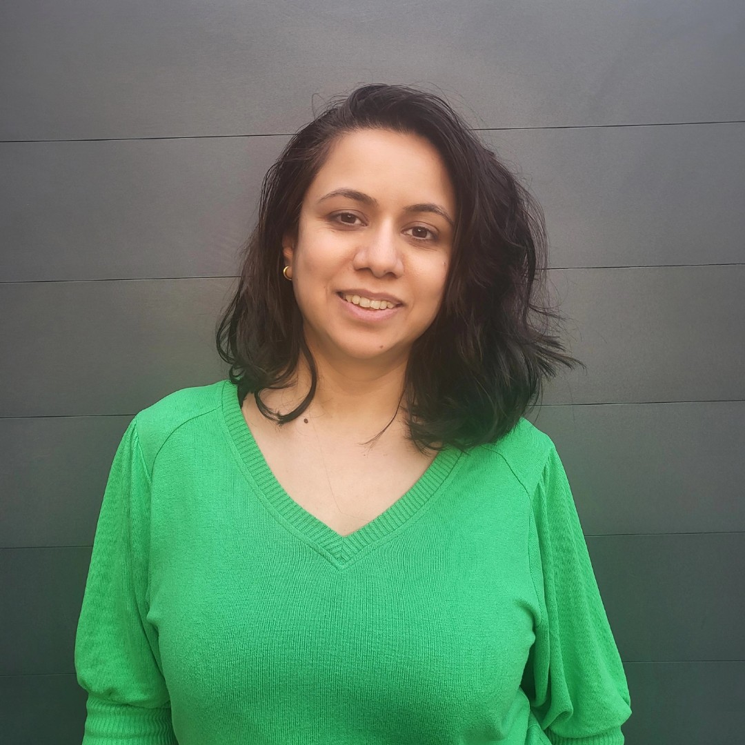 Pooja Boddupalli: Woman in a green jumper smiling at the camera