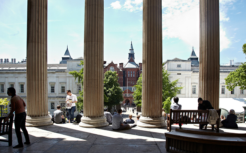Photo of students sitting on the UCL Portico during the summer