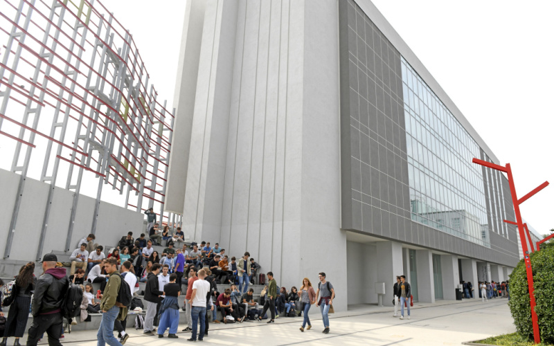 ngeneering students outdoor the modern architecture buildings of the Politecnico University, at Bovisa district, in Milan