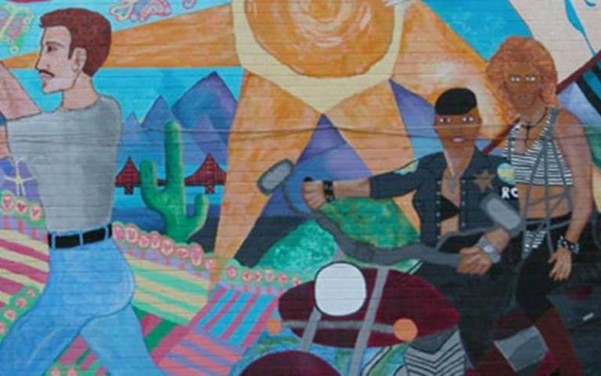 Graffiti showing man with moustache and two bikers in stylised desert
