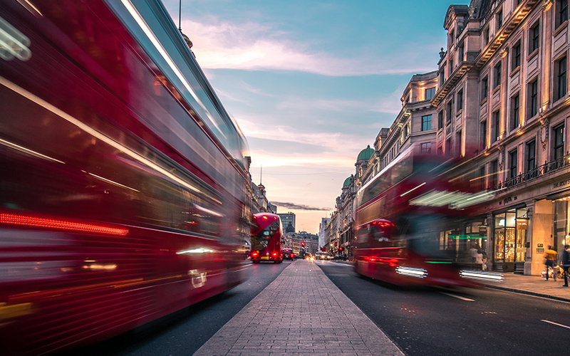 Double decker buses driving down Piccadilly, London, United Kingdom