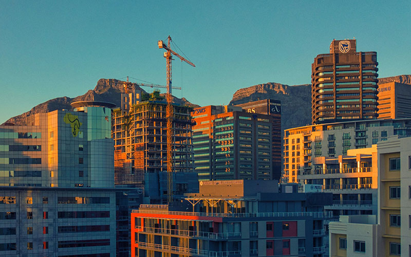 brown concrete buildings during daytime Sun rises over Cape Town, South Africa.