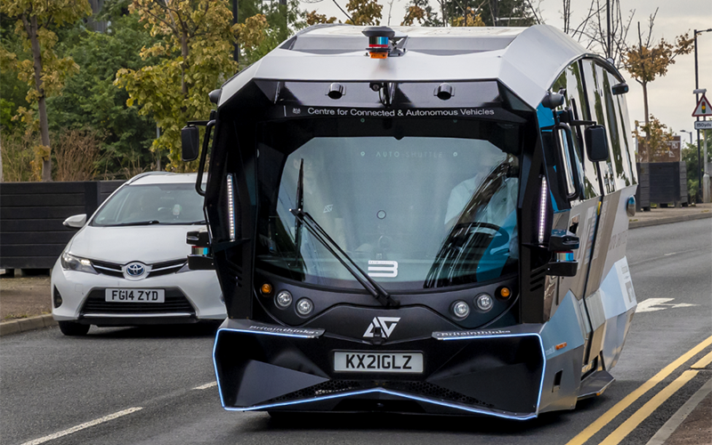 Futuristic bus drives on main road