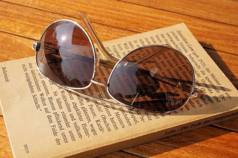 Sunglasses and book on the beach