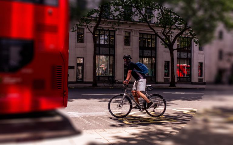 Man on bike with London bus