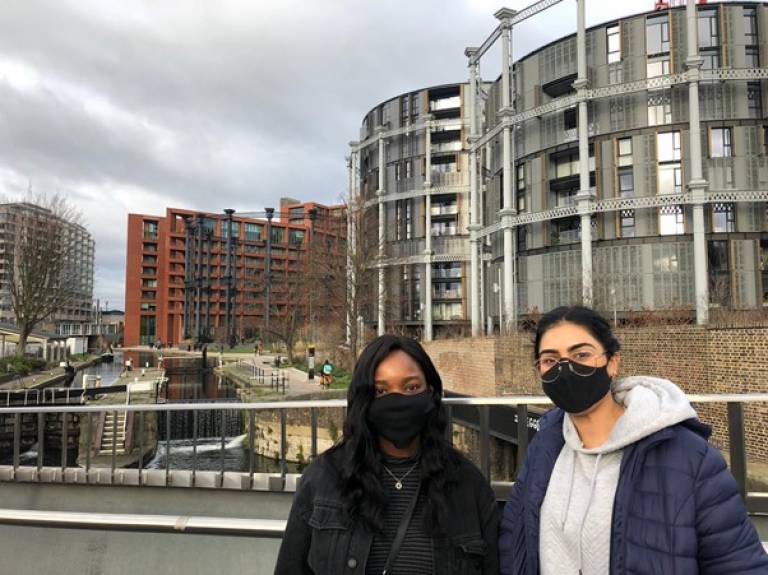Two female students in masks walking in London