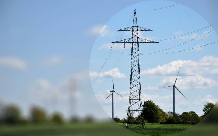 Pylons and wind turbines blurred