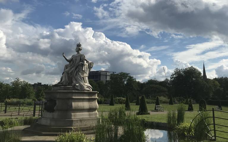 A statue of Queen Victoria in a royal garden