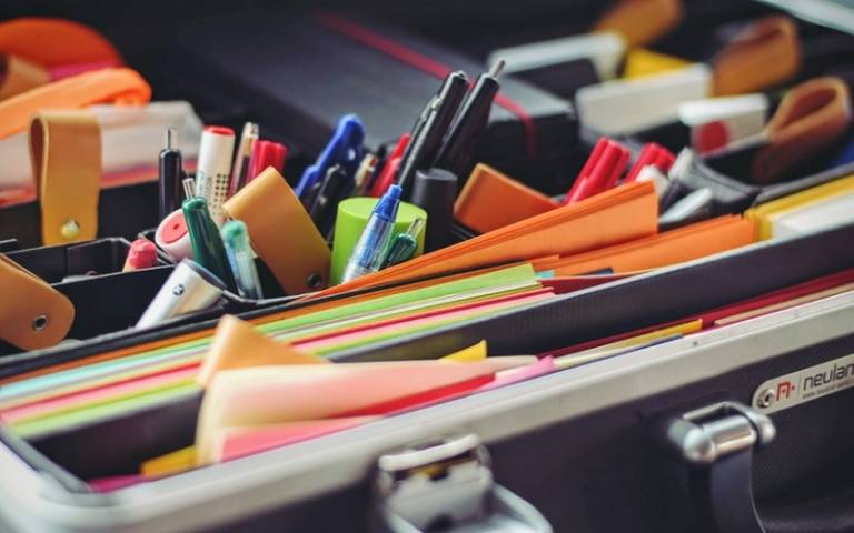 Closeup of pens and folders on a desk