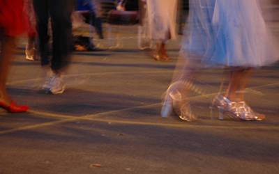 Feet of dancers in the street at night