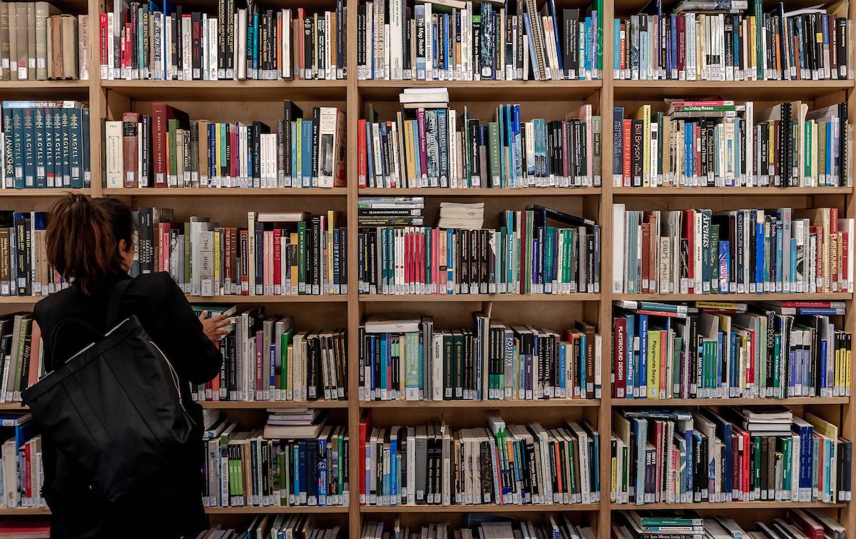 person browses shelves in library
