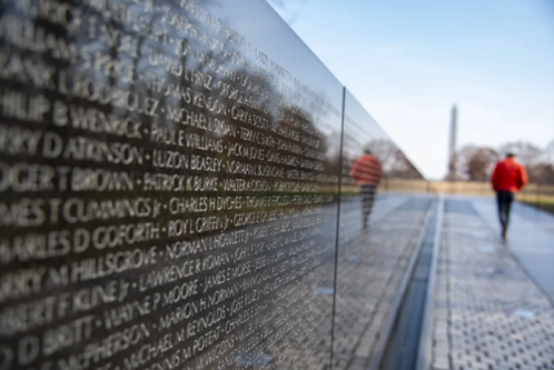 Close up of memorial, reflective surface with names written into it