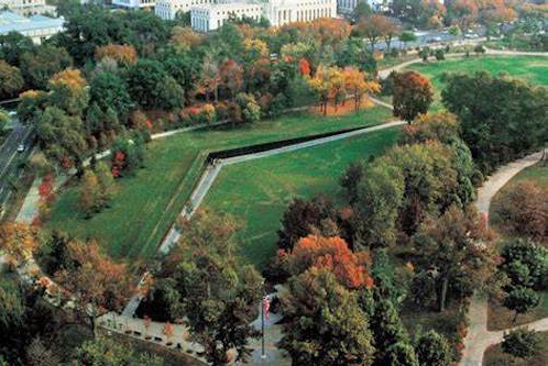 aerial shot of memorial, line with obtuse angle cutting through park with trees