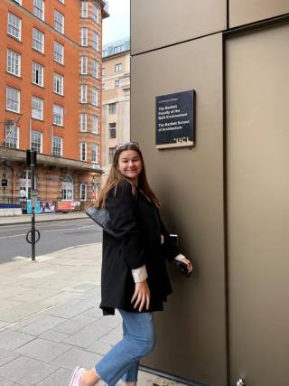 Student posing by an entrance to UCL