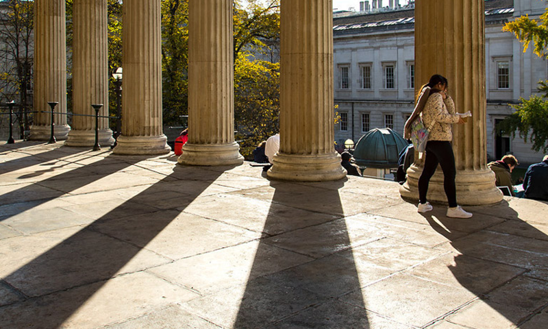 Student walking in portico