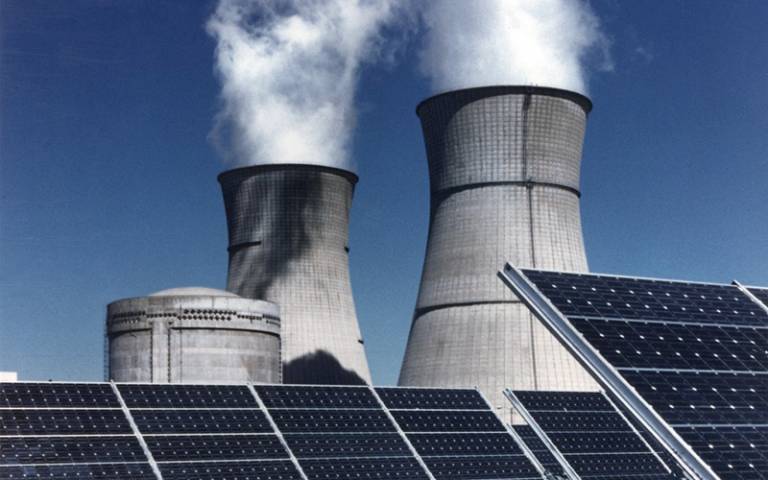 Cooling towers with solar panels in the foreground