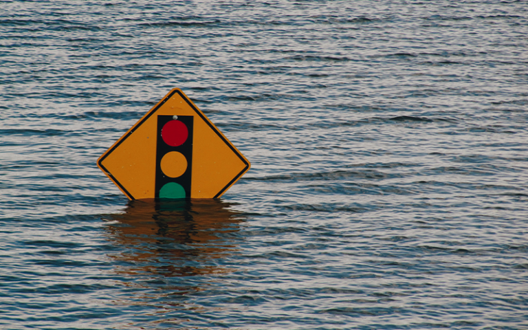 Traffic light sign in high flood water 
