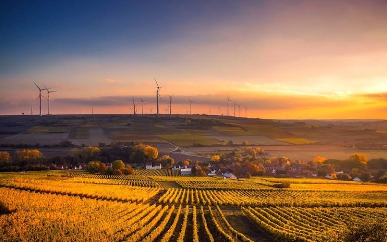 Sunset behind valley with wind turbines