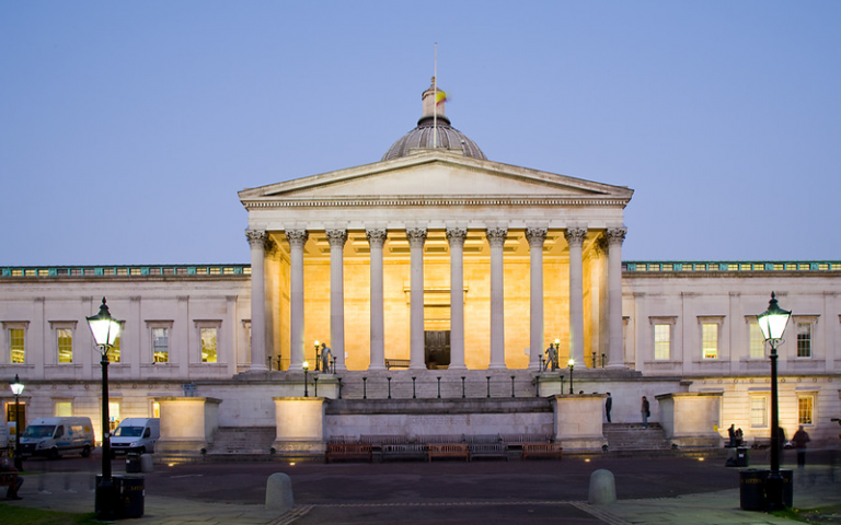 UCL Wilkins building lit up at night 