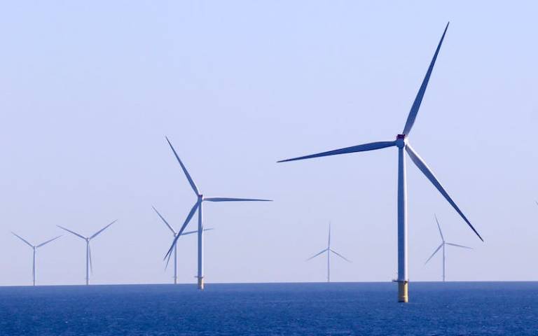 Windmills against a blue sea