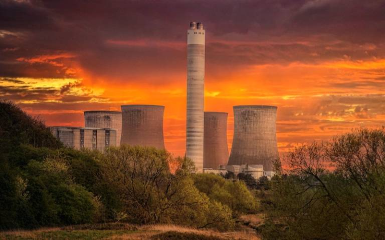 White Nuclear Plant Silo Under Orange Sky at Sunset