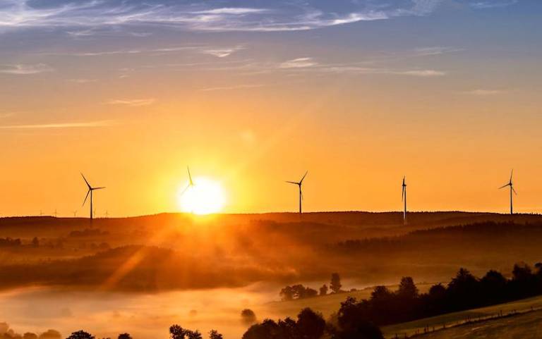 Image of wins turbines against a sunset