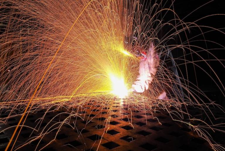 Image of a person metalworking with sparks