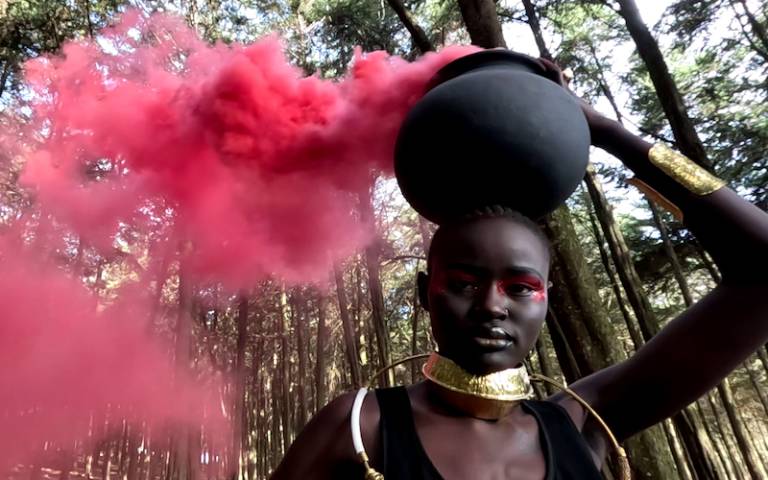 Kenyan woman holding a smoking censer, from the Smoke Jumpers film